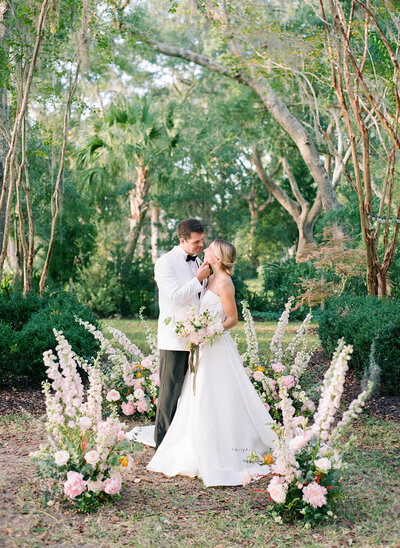 Charleston SC Bride and Groom in floral arch