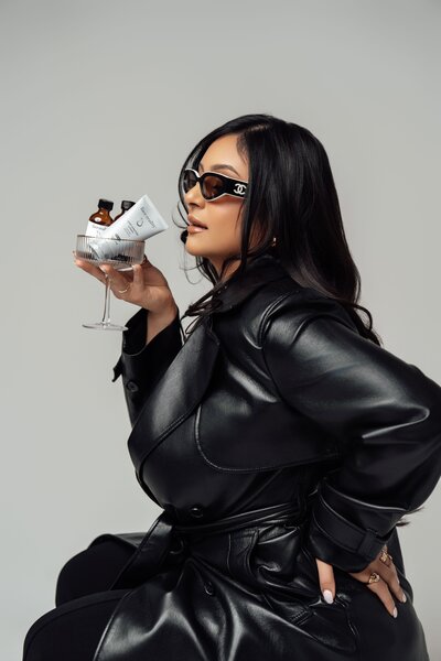 Bianca holding a glass with skincare products inside