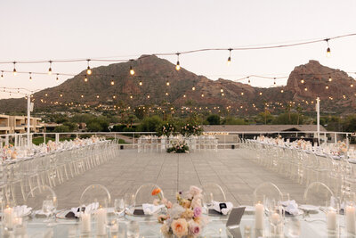 Candlelit colorful wedding reception at Mountain Shadows Resort rooftop in Paradise Valley, AZ features Snapdragon Bloom Bar wedding floral designer.