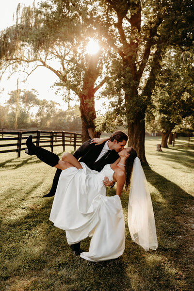 Groom twirling bride in her dress during golden hour portraits in Frankfort, IL