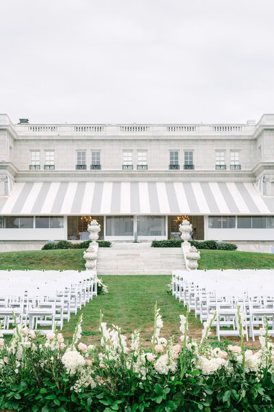 close up of greenery in front of a grand white building