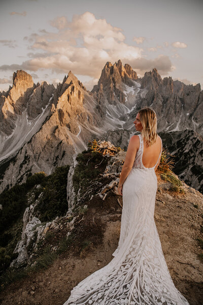 bride poses with mountains in background