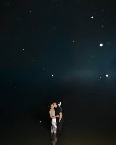 Married couple eloping at midnight at a secluded beach in Minnesota under the stars