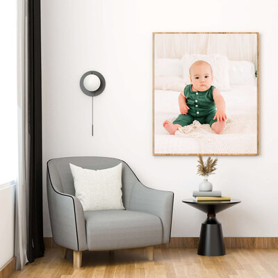 framed photo of little boy in green holding toes during Branson Mo baby milestone session