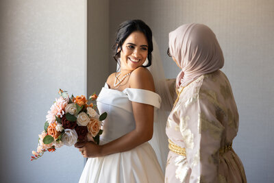 A Ohio bride and her mother share a private moment while getting ready for on her wedding day, in Toledo, Ohio. Photo taken by Aaron Aldhizer