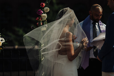 bride holding her veil in joshua tree wedding ceremony