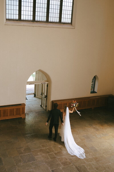 happy couple hugging at wedding, woman in red dress