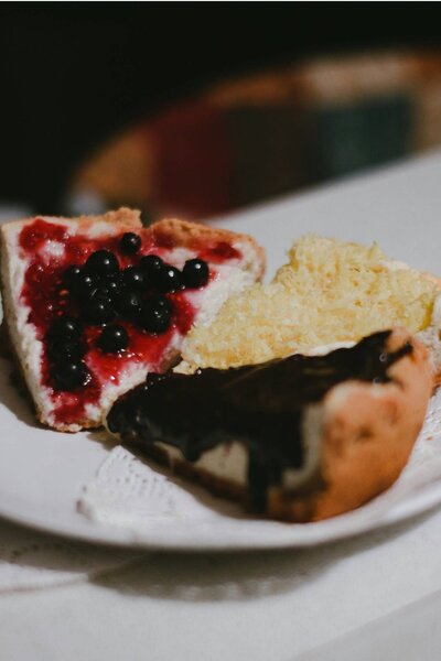 A single slice of cake with a bite taken out of it, sitting on a plate—symbolising the quiet aftermath of emotional labour, indulgence, or something unfinished