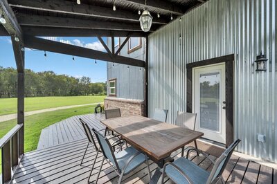 Outdoor dining with seating for six in this 4-bedroom- 4-bathroom historical home with guest house on 3 acres of land in the greater Waco area.