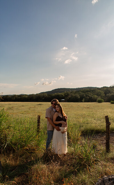 beautiful golden hour maternity session in a field with hills indiana carmel westfield fishers