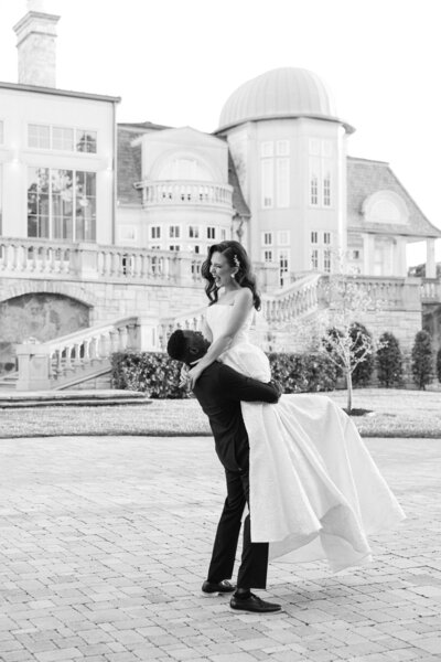 a groom lifting his bride in the air