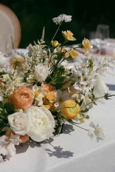 photo of flower arrangement sitting on table with white linen table cloth taken by Philly city hall elopement photographer
