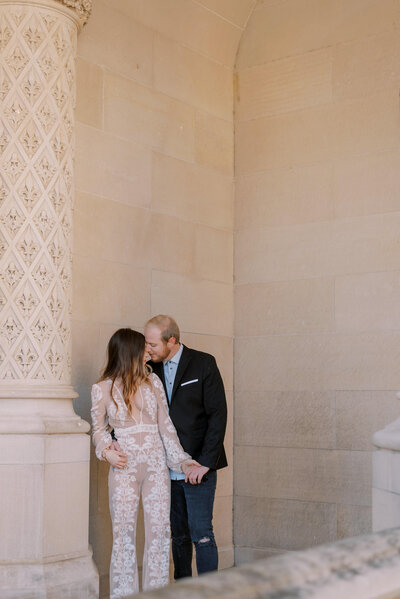 Bride and groom kissing at the Biltmore Estate bride wearing an ivory lace jumpsuit