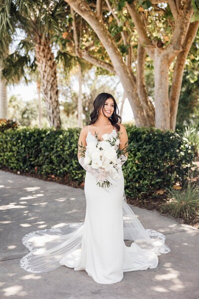 Bride posing with bouquet in Florida by 35mm film wedding photographer Noble Photo Co