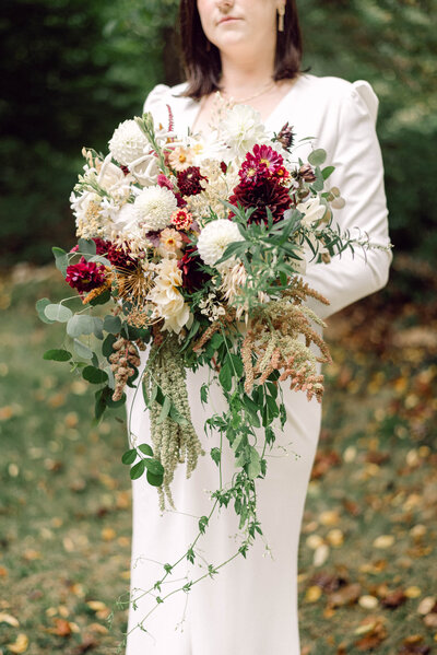 Bride holding a stunning bouquet designed by Fleuressence Floral Design at her Richmond backyard wedding.