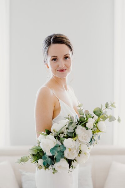 Bride reading her vows to the groom with water behind them