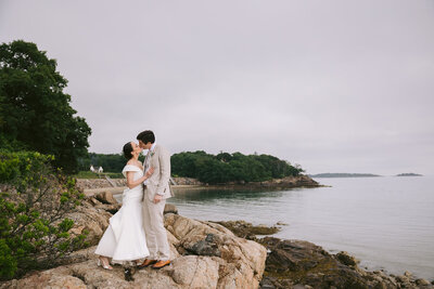 Wedding couple kiss cliffside at Misselwood in Beverly, MA