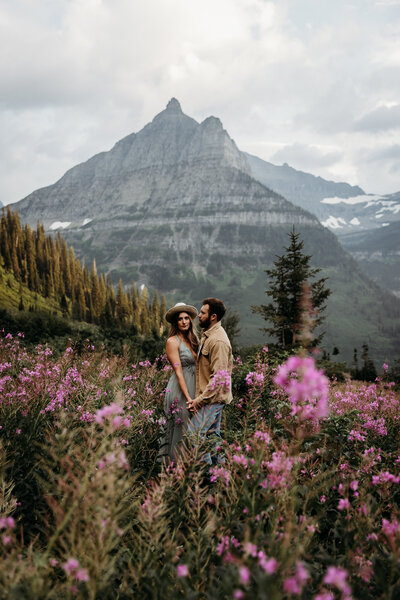 couple holding hands at glacier national park