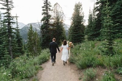 Couple walking along a trail in the mountains.