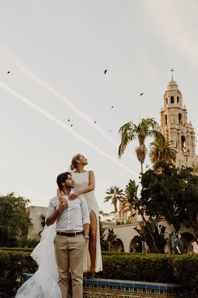 bride and groom with birds flying