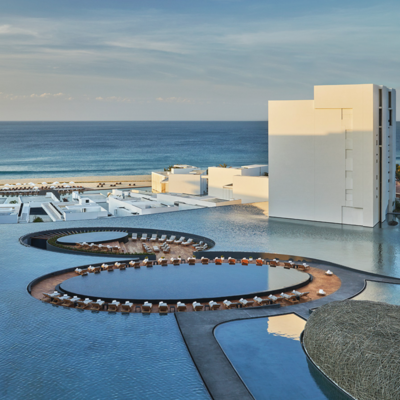 An image of the pools at Viceroy Los Cabos and the ocean in the background