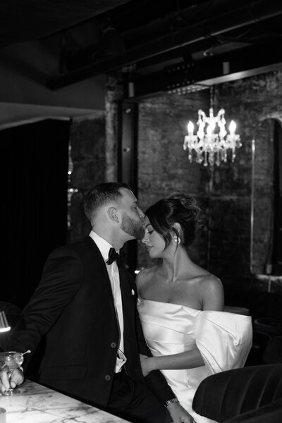 Bride & groom kissing under veil at. Philadelphia. Cricket Club