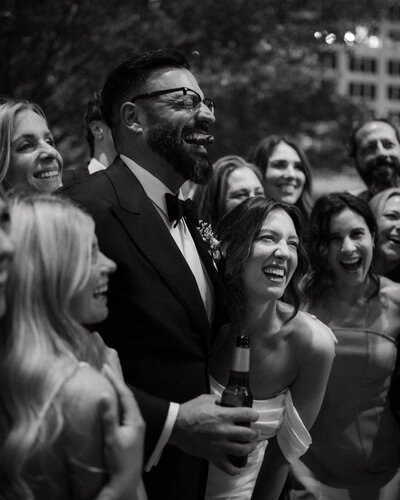 Friend fanning the bride before her backyard wedding in Columbia, MO.