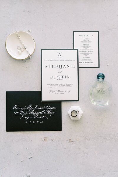 Black and white modern invitation with bold lettering and calligraphy