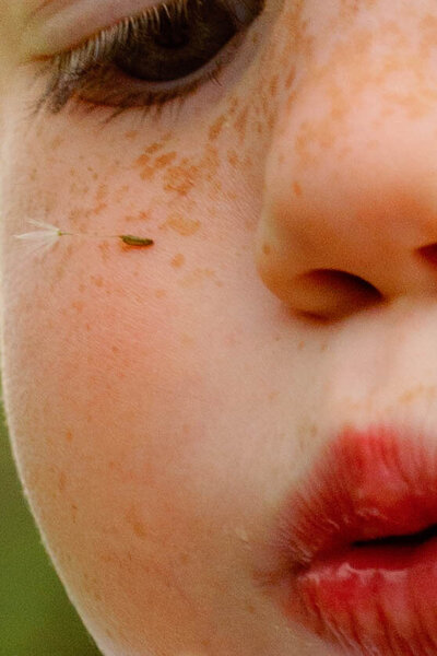 Film photograph of mother holding her daughter while her son grips a garden iron fence in downtown Chicago, capturing authentic, emotional, and intimate family moments in a relaxed documentary style.
