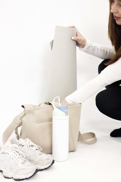 What to bring to your first Lagree fitness class—shoes, water, yoga mat, and gym bag setup at Rise Studio