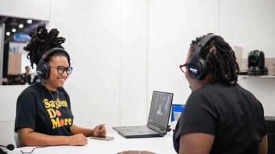 Alesia Hendley recording a podcast and smiling