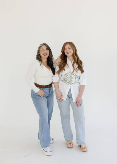 Holly and Nancy, co-founders of Klover Beauty, smiling at the camera during a professional brand photoshoot for their Maryland bridal beauty business.