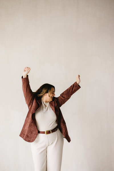woman holding her hands in the air while dancing
