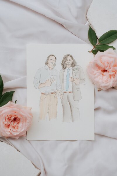 Watercolor illustration of two men posing with peace signs, surrounded by pink roses on white fabric.