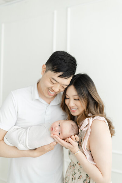 Parents hold newborn baby