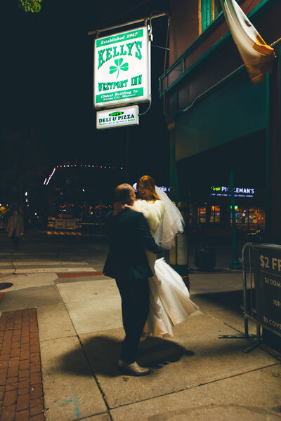 An indie LGBTQ+ couple’s moody editorial wedding portrait, photographed in a true-to-color style by Chelsea Stanford in Missouri.