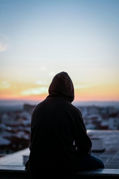 A man looking out at the city feeling calm after completing SSP