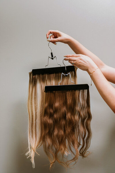 two wefts, one wavy curly and one straight in the best extensions salon in Madison, MS