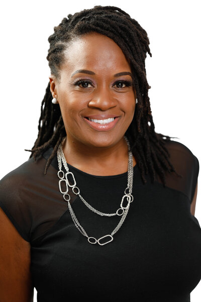 Professional headshot of a woman looking confidently at the camera and smiling.