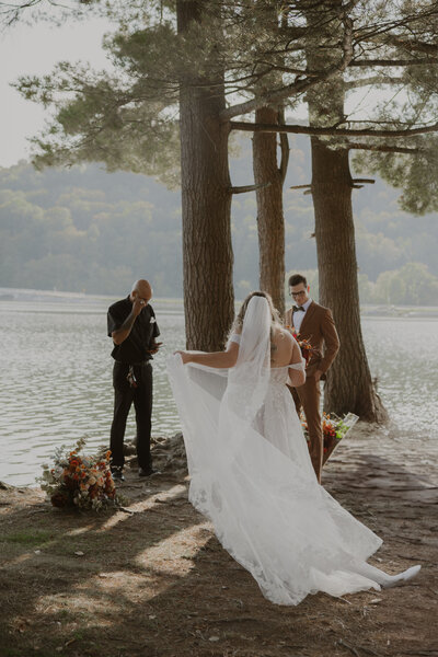 A photo of a bride walking up to her groom in a beautiful, intimate ceremony location on Red Lake at Allegany state park. Photo by Dash and Boheme Photography. 