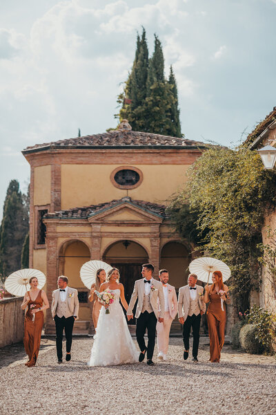 wedding party walk together at venue