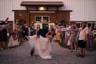 A couple in a dip kiss with a sparkler exit at Bear Creek Farms in Michigan.