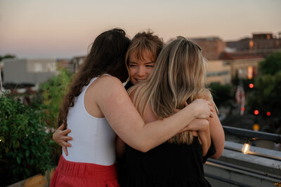 sal-caro-dc-sunset-proposal-friends-hug
