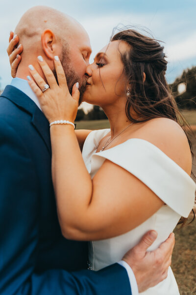 Bride and groom kissing after their Oklahoma wedding ceremony on a gloomy fall day