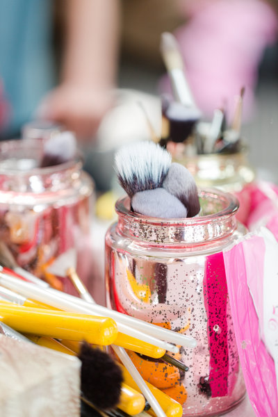 Pink mercury jars hold makeup brushes