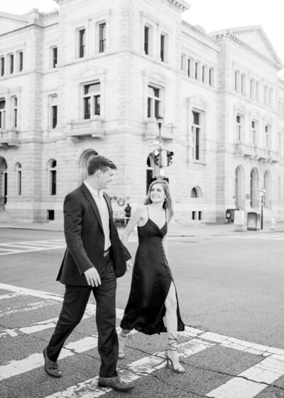 Couple holding hands walking in downtown charleston