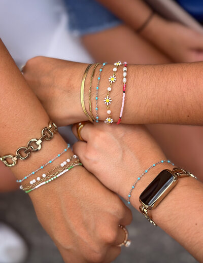 Three friends showing off their permanent bracelets from Jazzy's Glam Bar in Tampa, FL.