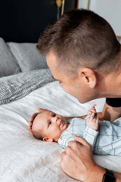Newborn Photographer, a father admires his little baby