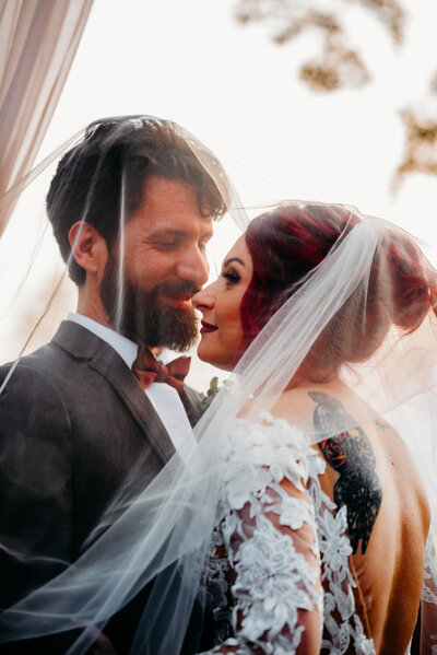 romantic wedding photo of bride and groom under the veil at the Oaks in baton rouge, louisiana