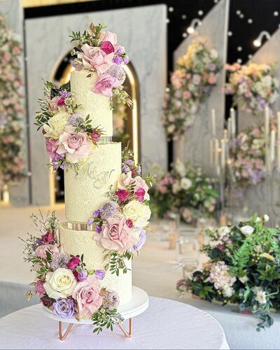Three tier wedding cake at the Kimpton Fitzroy Hotel London - white wafer paper ruffles on the base, with pink roses on the top tier & silver acrylic initials on the front